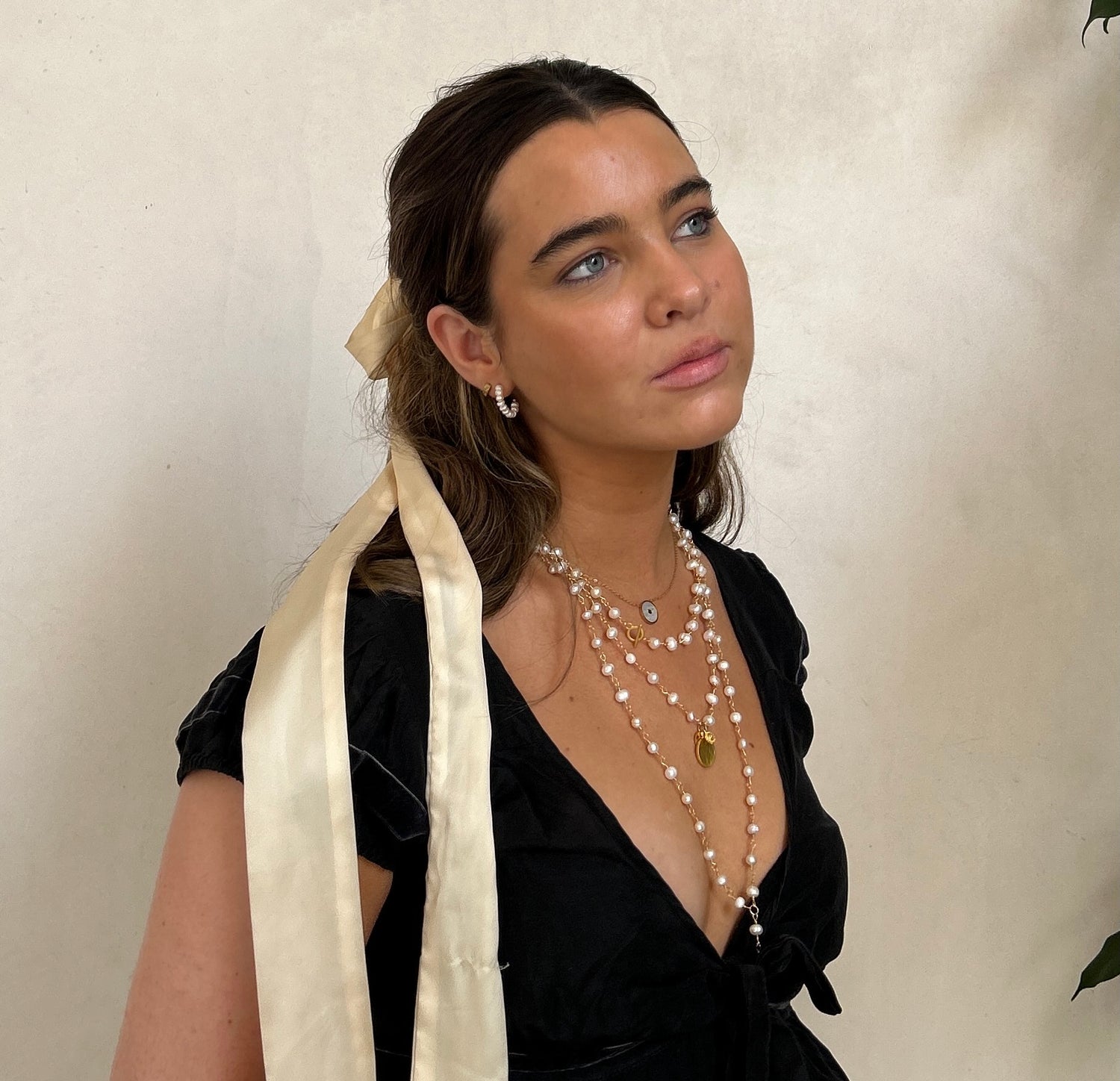 Iris Croft wearing layered pearl necklaces from Iris & I London
